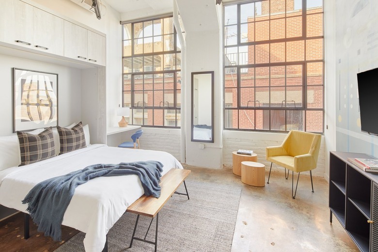 Modern bedroom with yellow accent chair